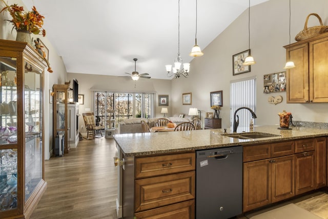 kitchen featuring ceiling fan with notable chandelier, vaulted ceiling, sink, dishwasher, and dark hardwood / wood-style floors