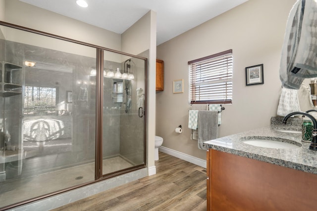 311 Cedar Glade Dr, Branson West, MO 65737 - bathroom featuring vanity, toilet, wood finished floors, a shower stall, and baseboards