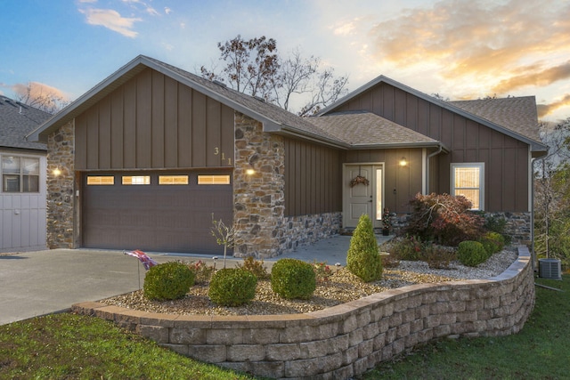 view of front of house with central AC and a garage