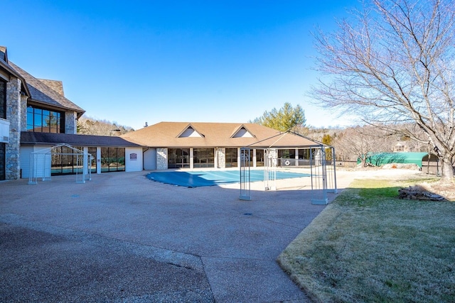 view of pool with a lawn