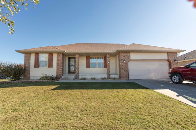 ranch-style house featuring a garage and a front lawn