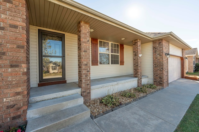 property entrance featuring a garage and covered porch