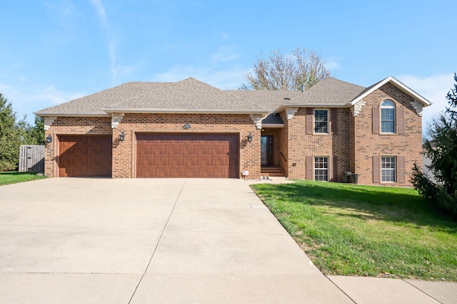 view of front of property with a garage and a front lawn