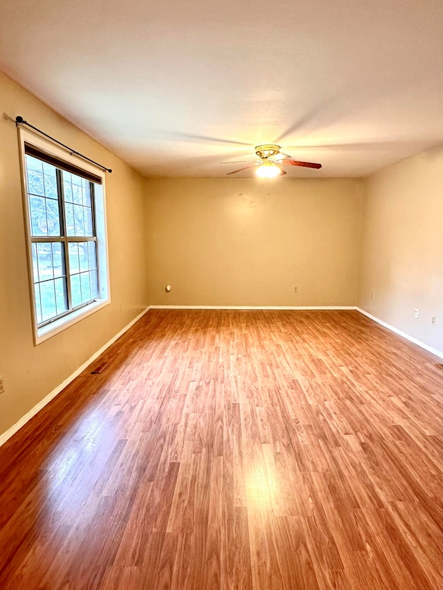 spare room featuring ceiling fan and light wood-type flooring