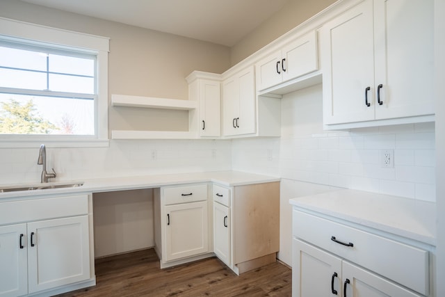 kitchen featuring white cabinetry, decorative backsplash, dark hardwood / wood-style flooring, and sink