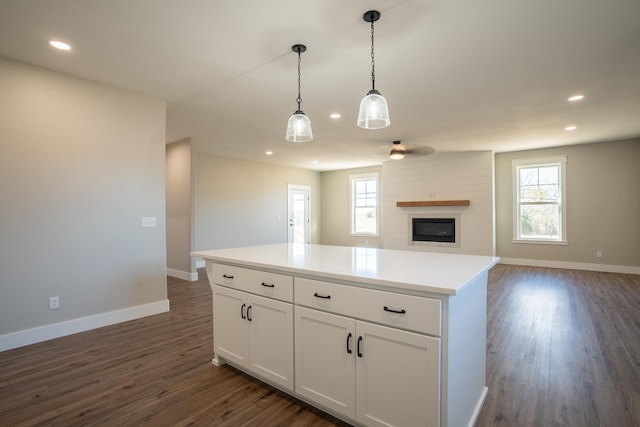 kitchen with white cabinetry, plenty of natural light, hanging light fixtures, and dark hardwood / wood-style flooring