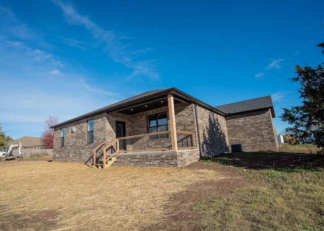 rear view of house featuring cooling unit