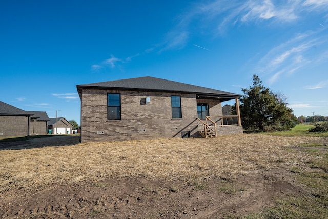 rear view of house featuring a lawn