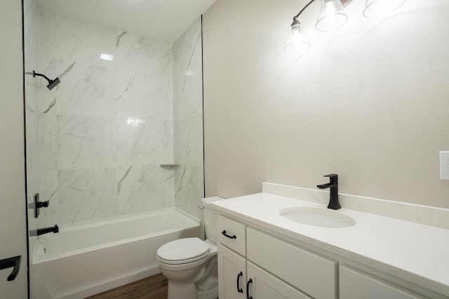 full bathroom with toilet, tiled shower / bath combo, vanity, and wood-type flooring