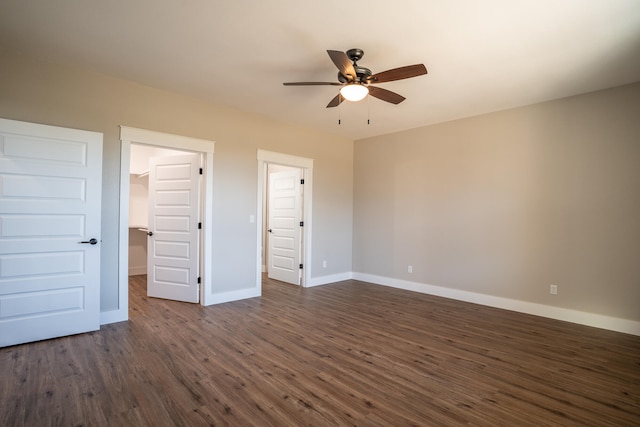 unfurnished bedroom with ceiling fan and dark hardwood / wood-style flooring