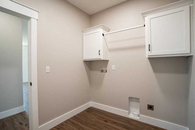 clothes washing area with hookup for an electric dryer, dark hardwood / wood-style flooring, washer hookup, and cabinets