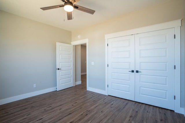 unfurnished bedroom featuring dark hardwood / wood-style floors, ceiling fan, and a closet