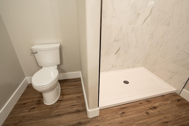 bathroom with walk in shower, wood-type flooring, and toilet