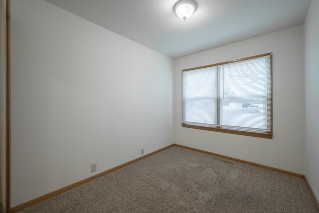 empty room with carpet flooring