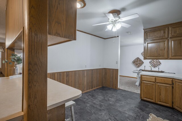 kitchen with wooden walls and ceiling fan