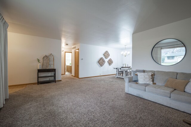 carpeted living room featuring a notable chandelier