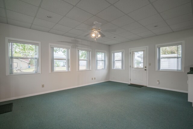 spare room with carpet floors, ceiling fan, and a healthy amount of sunlight