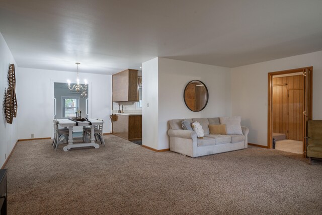 unfurnished living room with carpet flooring and a chandelier