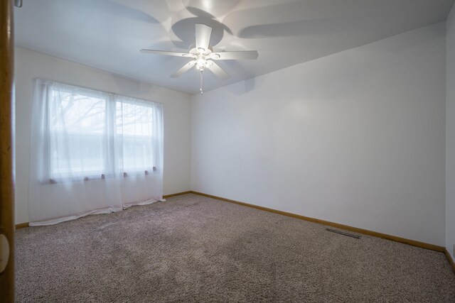 carpeted spare room with ceiling fan