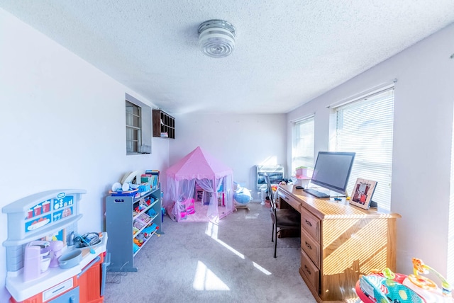 home office with light carpet and a textured ceiling