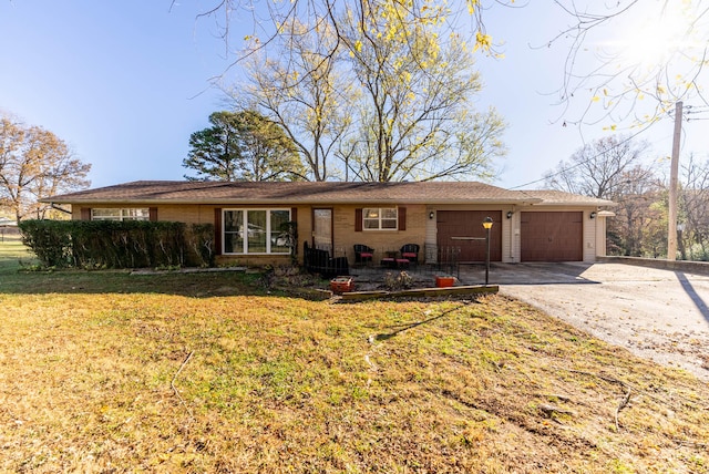 ranch-style house with a front yard and a garage