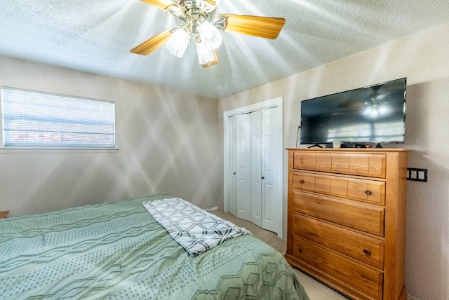 bedroom featuring ceiling fan, a closet, and a textured ceiling