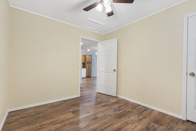 empty room with dark hardwood / wood-style floors and crown molding