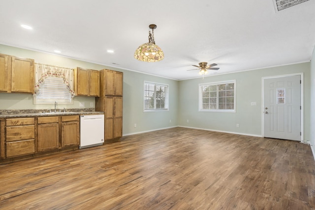 kitchen with crown molding, white dishwasher, dark wood-type flooring, and decorative light fixtures