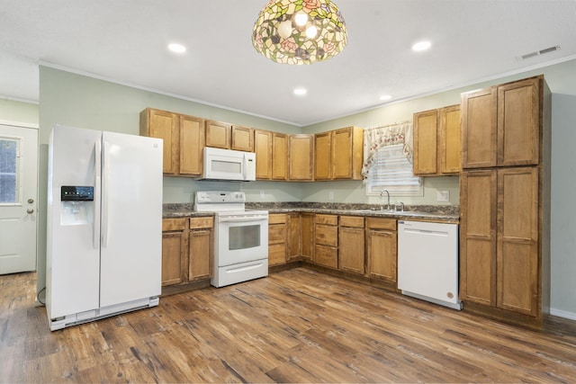 kitchen featuring sink, dark wood-type flooring, pendant lighting, white appliances, and ornamental molding