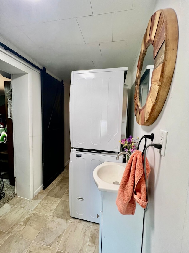 bathroom with vanity and stacked washer and clothes dryer