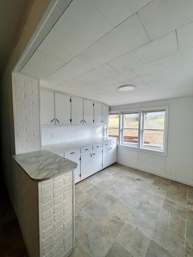1612 S Jefferson St, Ava, MO 65608 - kitchen with stone tile floors, white cabinets, and light countertops