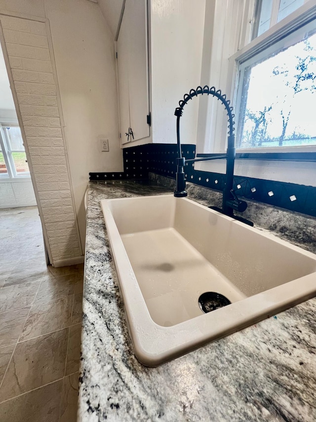 interior details with white cabinets and sink