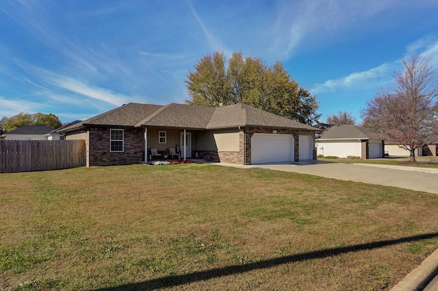 ranch-style house featuring a front yard and a garage