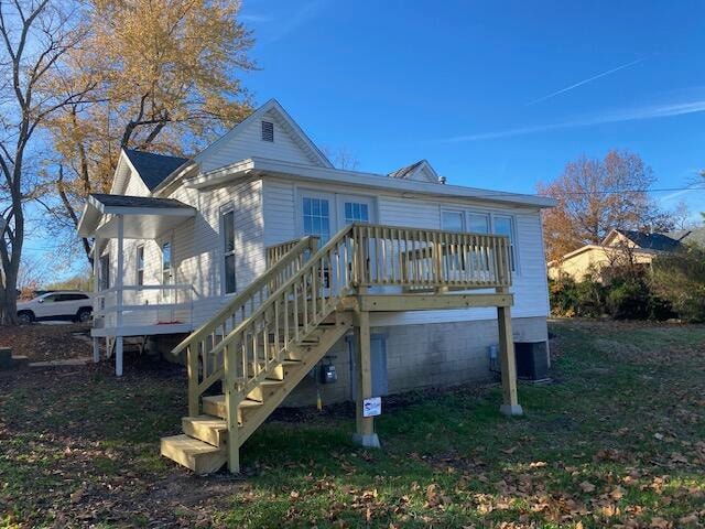 rear view of house featuring a deck