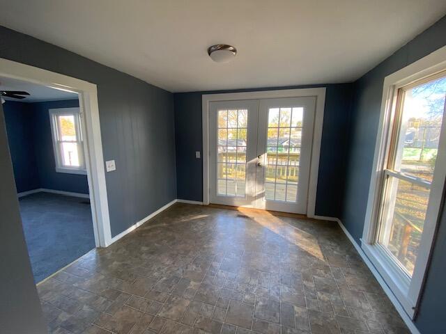 unfurnished room featuring french doors and a wealth of natural light