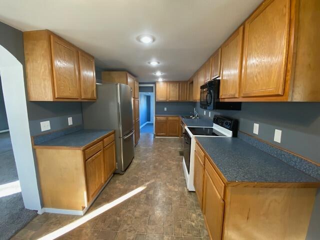 kitchen with stainless steel refrigerator and white electric stove