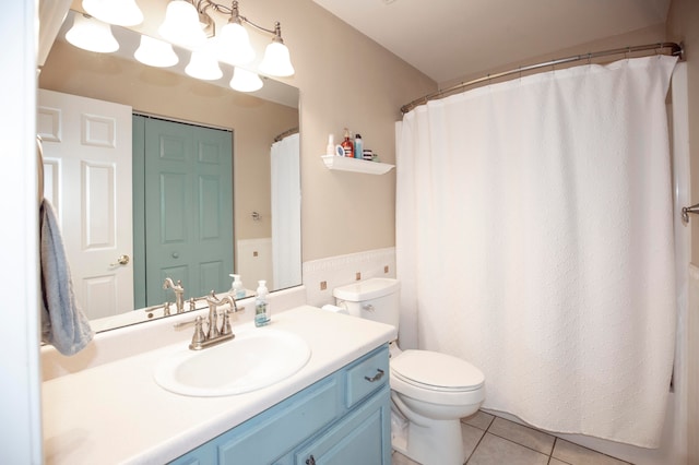 bathroom featuring tile patterned floors, vanity, and toilet