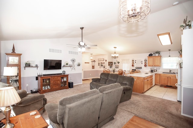 carpeted living room with sink, ceiling fan with notable chandelier, and lofted ceiling