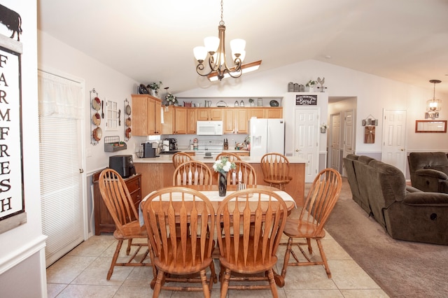 tiled dining area featuring lofted ceiling and a chandelier