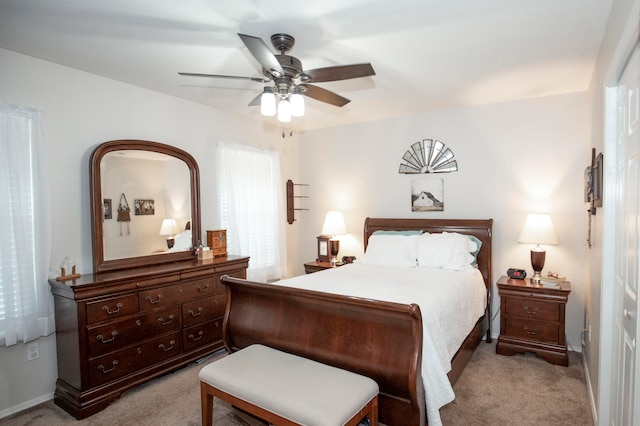 bedroom featuring ceiling fan and light carpet