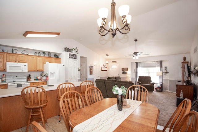 carpeted dining room featuring ceiling fan with notable chandelier and lofted ceiling