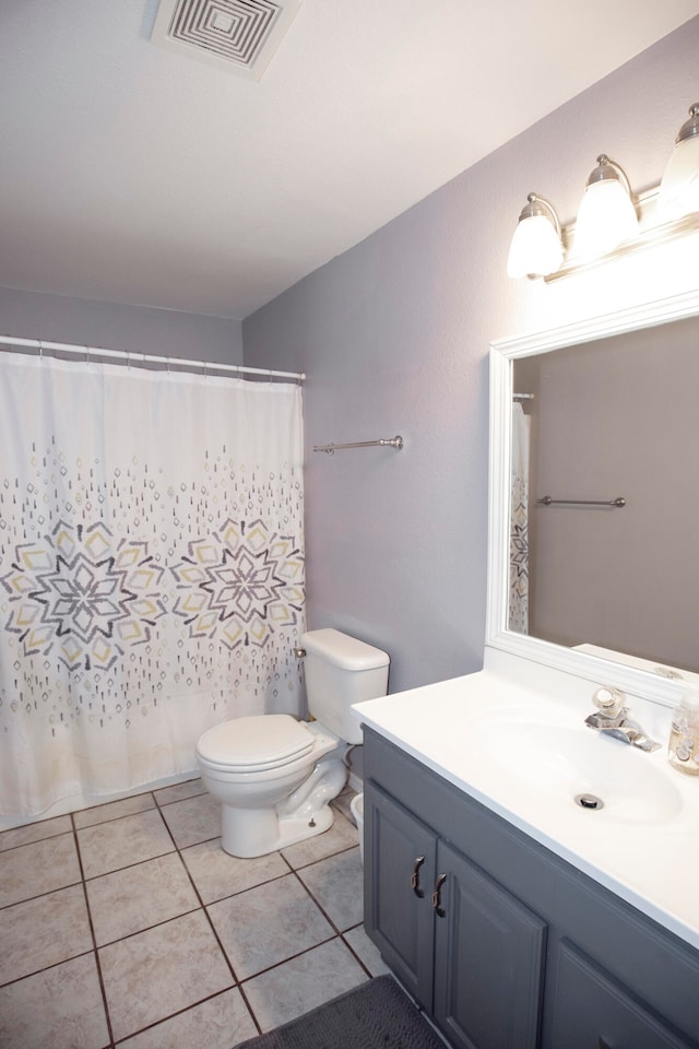 bathroom featuring tile patterned floors, vanity, and toilet