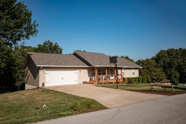 ranch-style house featuring a porch, a front yard, and a garage