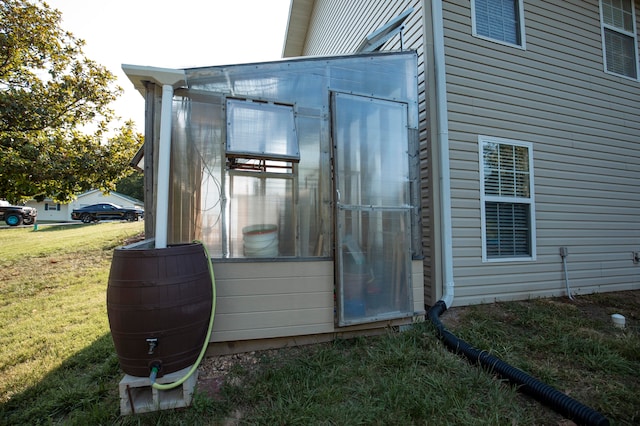 entrance to property with a lawn