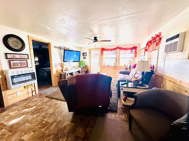 living room featuring heating unit, wooden walls, dark hardwood / wood-style flooring, and a textured ceiling