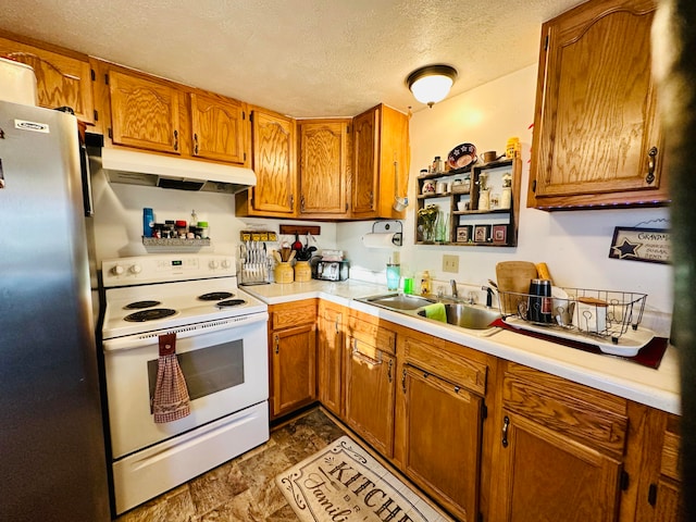 kitchen featuring white electric range oven, sink, a textured ceiling, and stainless steel refrigerator