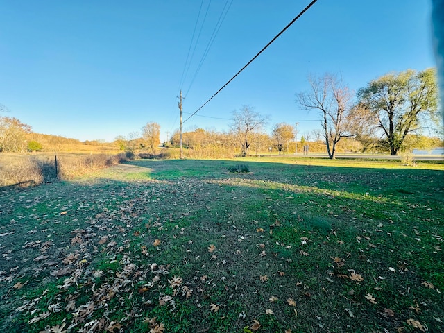 view of yard with a rural view