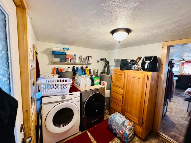 laundry room with independent washer and dryer, a textured ceiling, and water heater