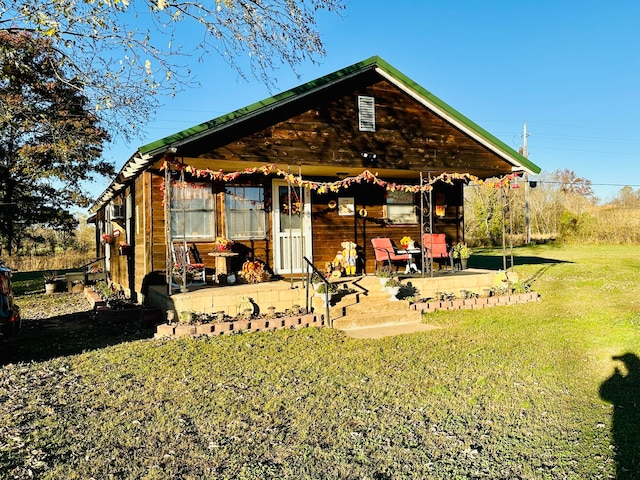 back of property with a lawn and a patio area