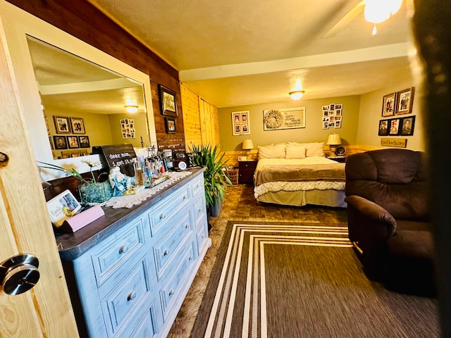 bedroom featuring ceiling fan and wood walls